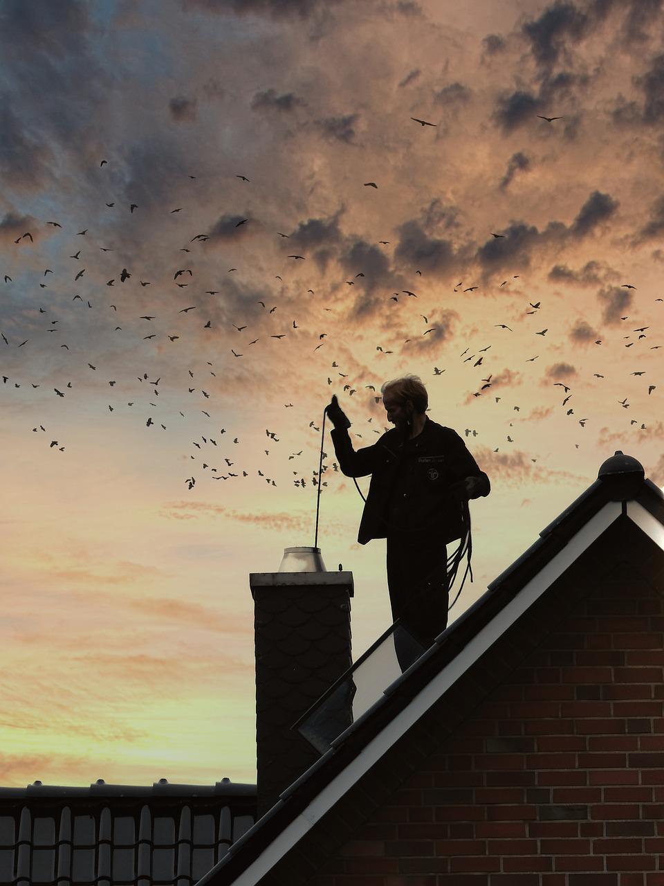 Homeowner getting their chimney cleaned by a chimney repair service in CT