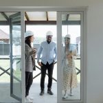 Real estate agent showing potential buyers a house