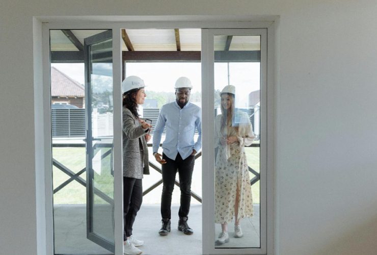 Real estate agent showing potential buyers a house