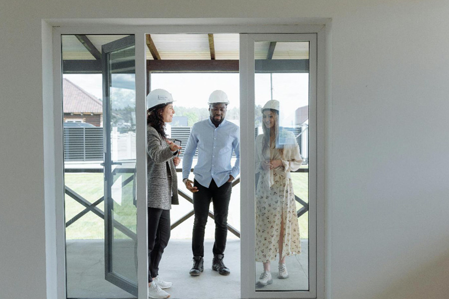 Real estate agent showing potential buyers a house